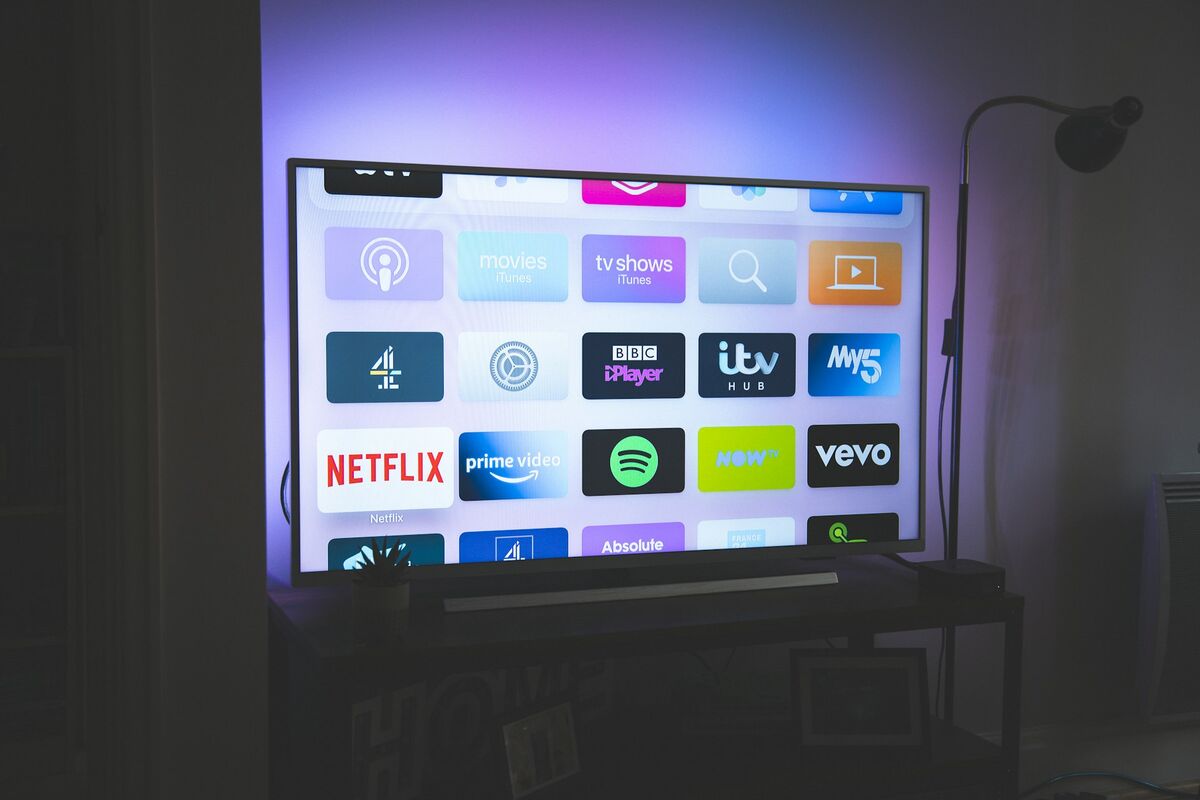 Modern living room with a large smart TV displaying a 4K streaming interface