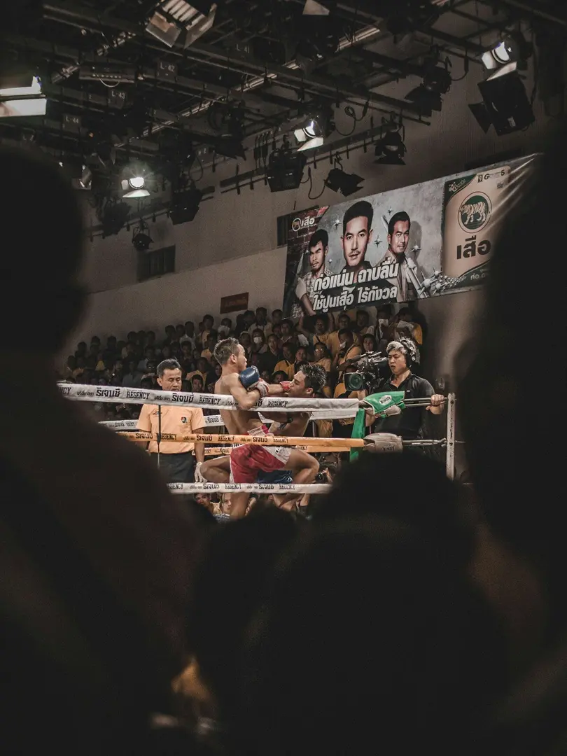 Boxing ring under bright arena lights before a professional fight night