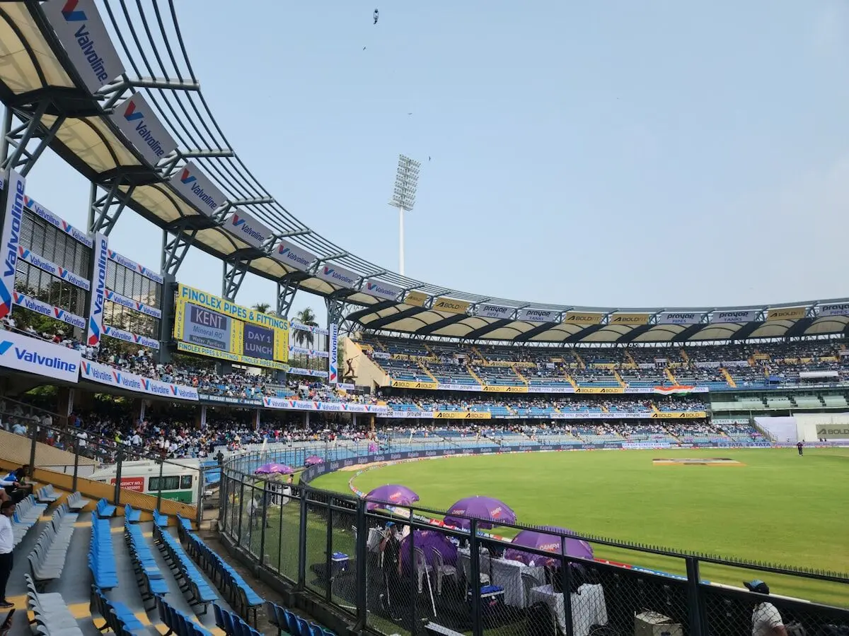 Packed cricket stadium with thousands of fans watching a live match