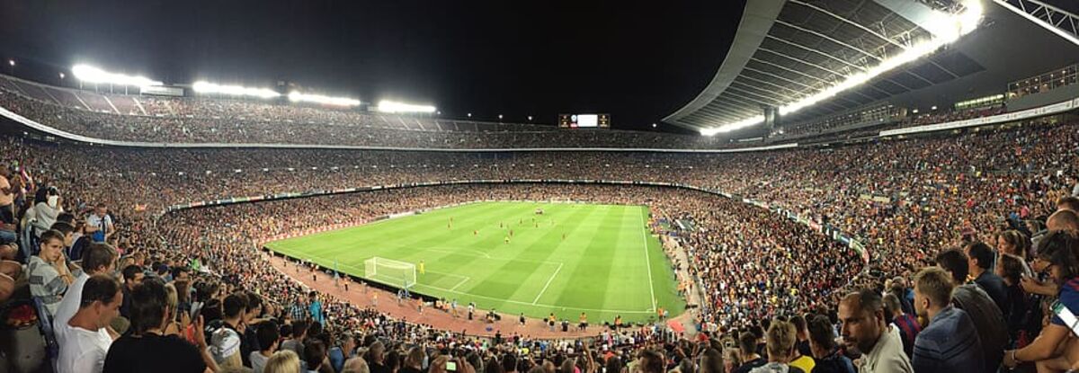 Football stadium lit up at night during a live Premier League match