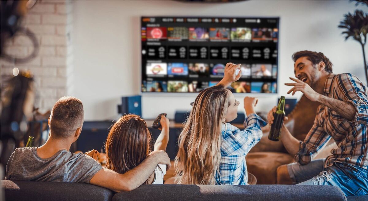 Try IPTV free for 24 hours — stream on any device Family streaming live TV together on a large screen in their living room