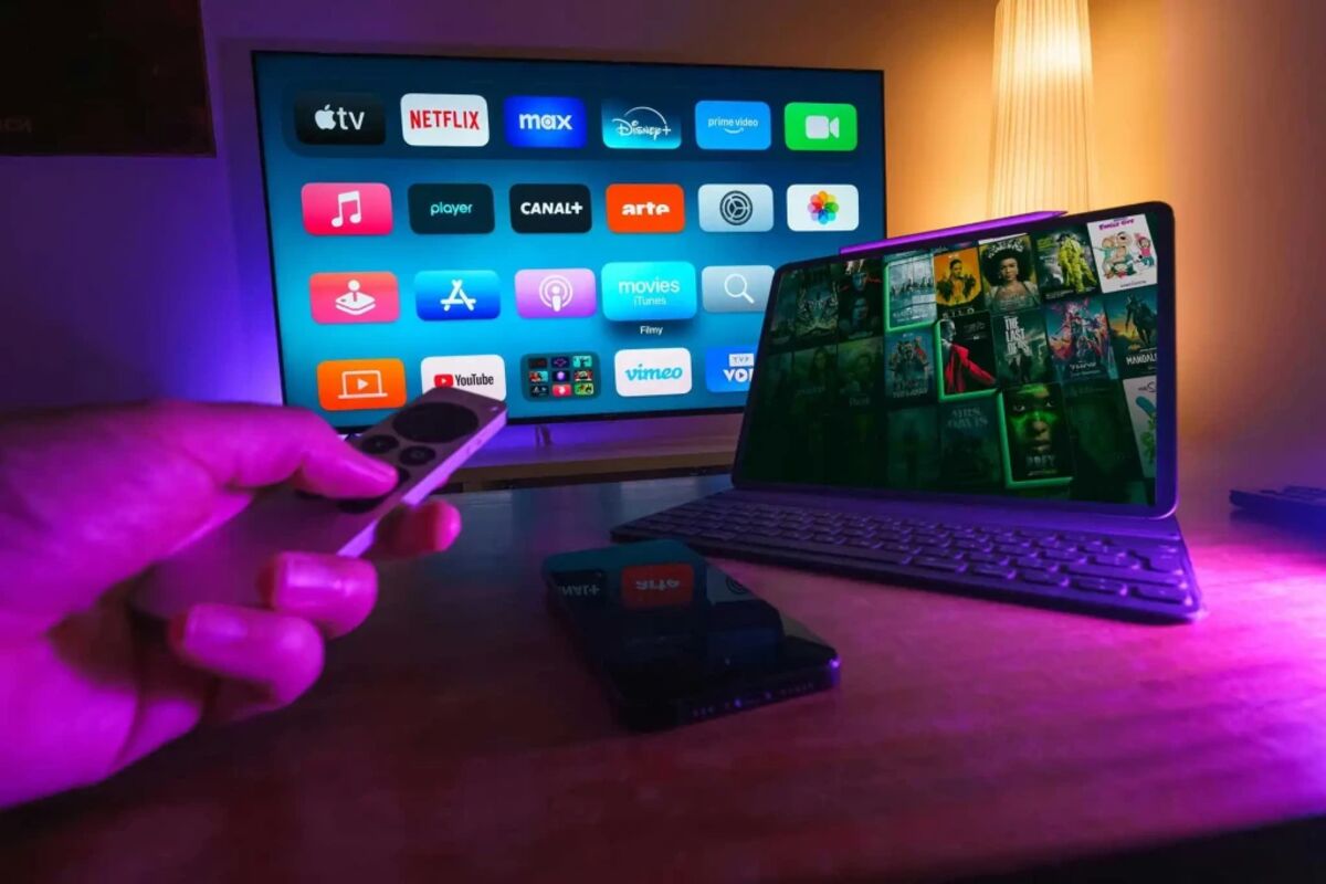 Browse 45,000+ live channels and 80,000+ on-demand titles Remote control pointed at a television screen showing streaming apps and live TV channels